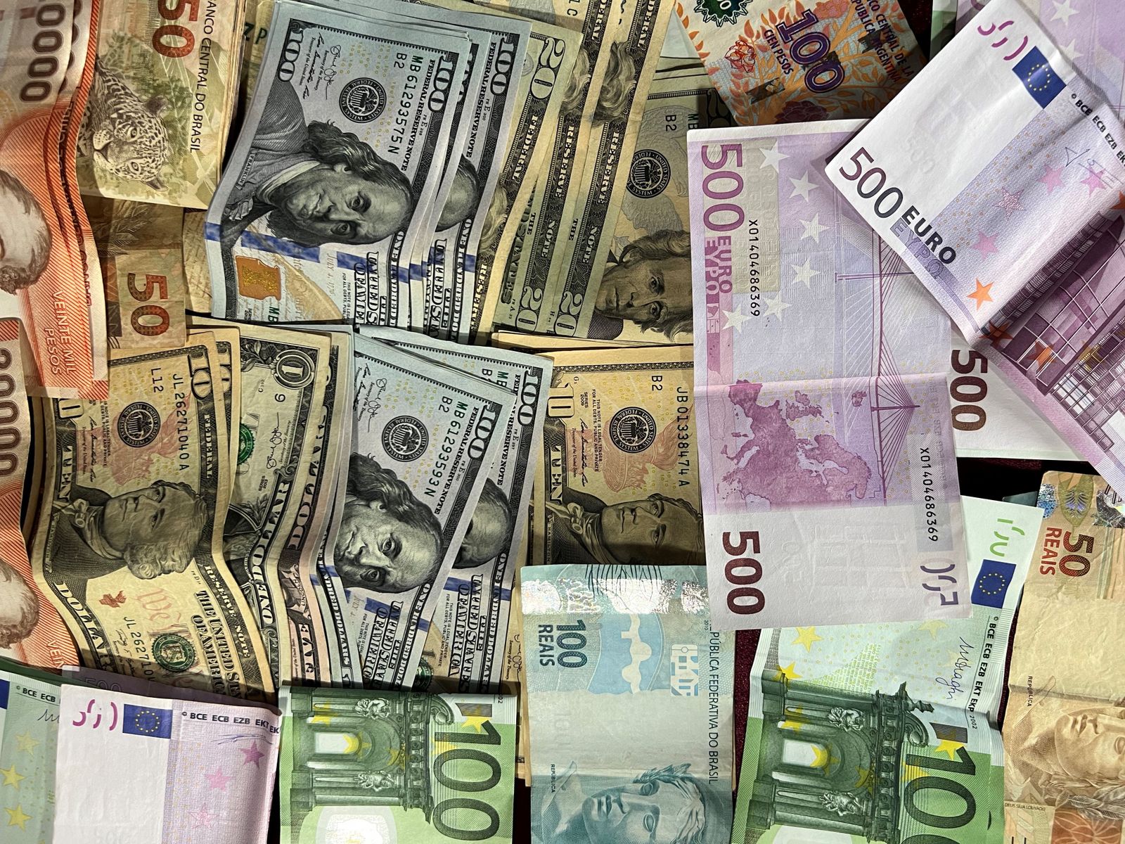 Assorted international banknotes representing forex currency pairs